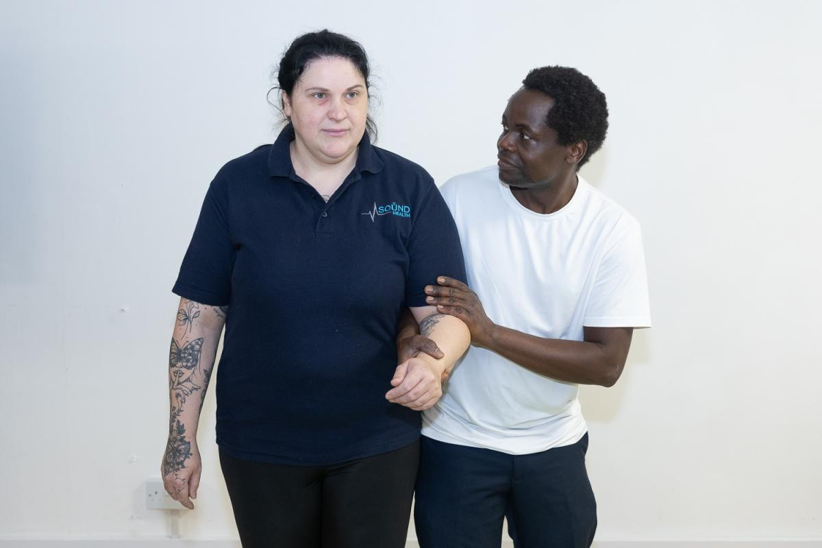 Soundhealth trainer demonstrating safe support during practical PMVA training